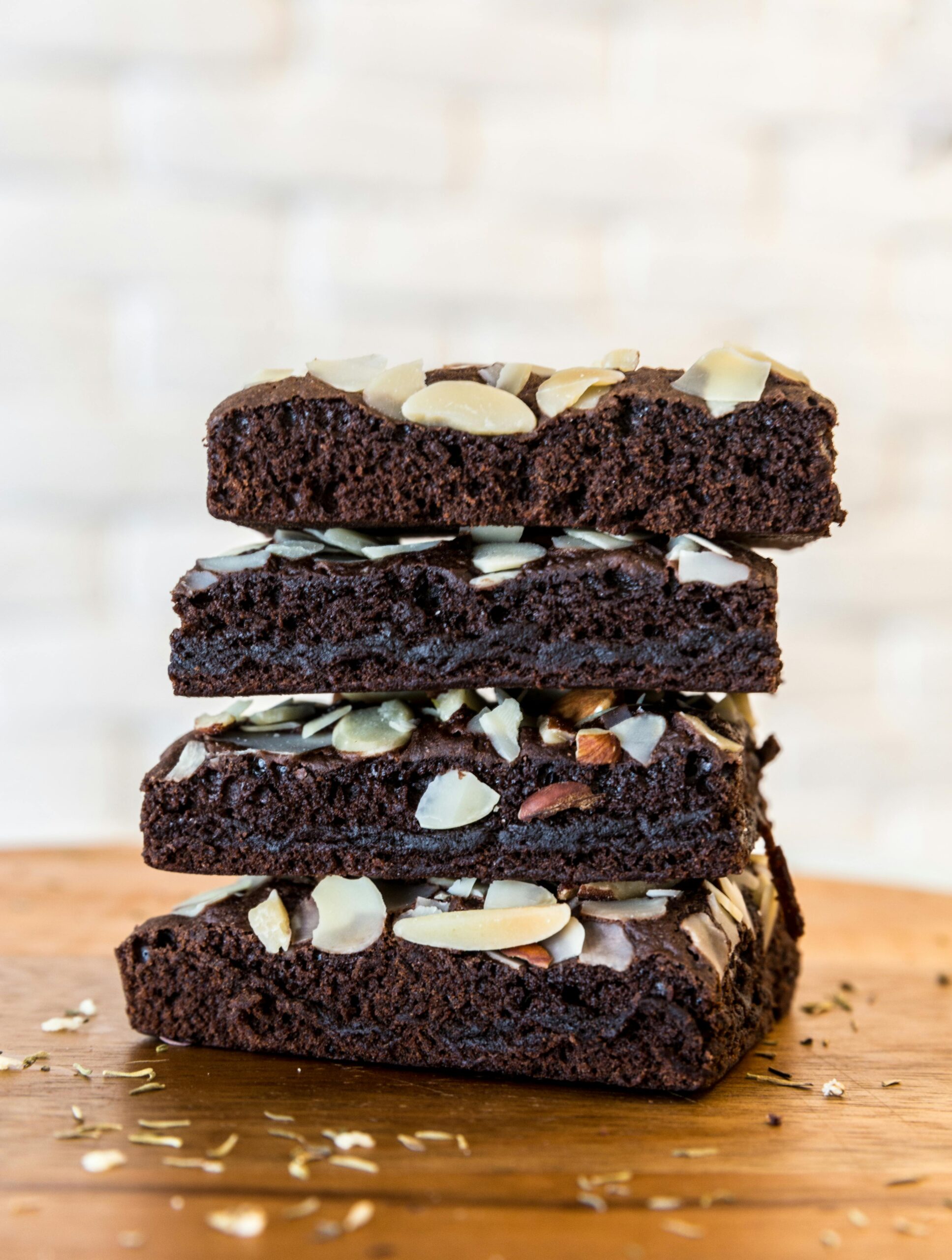 Rich and moist chocolate brownies topped with almond slices, perfect for dessert lovers.